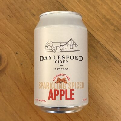 photo a can of sparkling spiced apple lying down on a bench